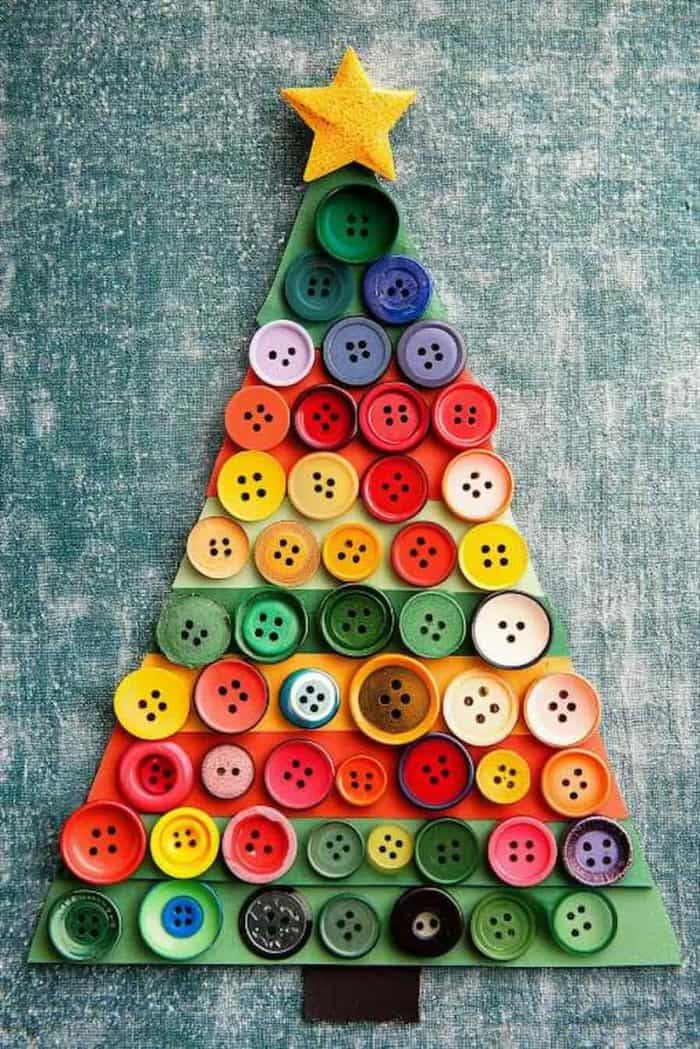 A Christmas tree made of colorful buttons arranged on a textured blue-green background.